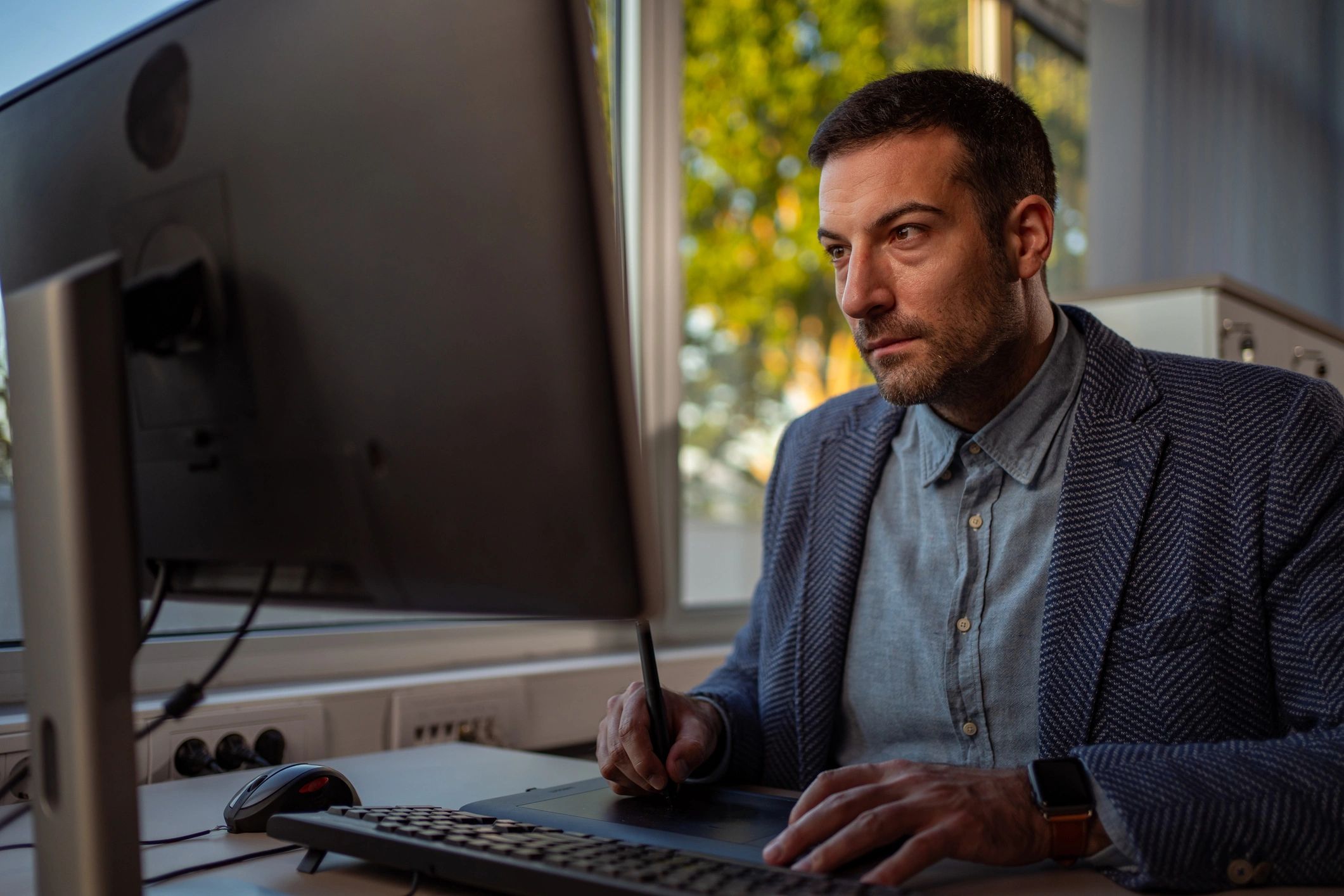 Editor reviewing detailed work at a desk