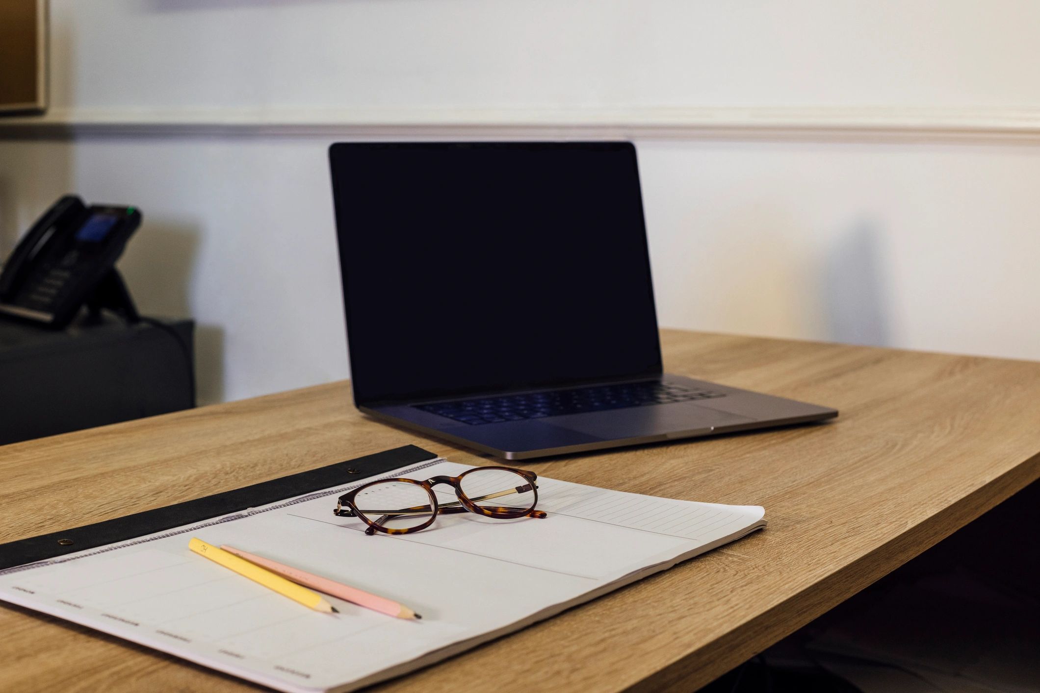 Academic planning materials and laptop on desk